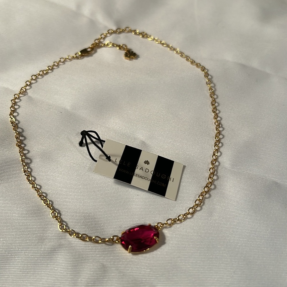 Lele Sadoughi necklace, gold-tone, dark pink oval faceted stone. 18” adjustable